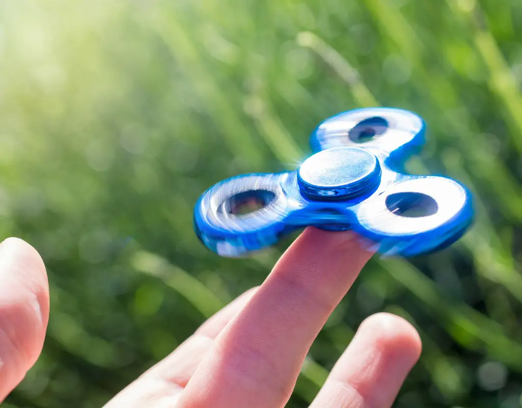 fidget spinner being spun on mans finger