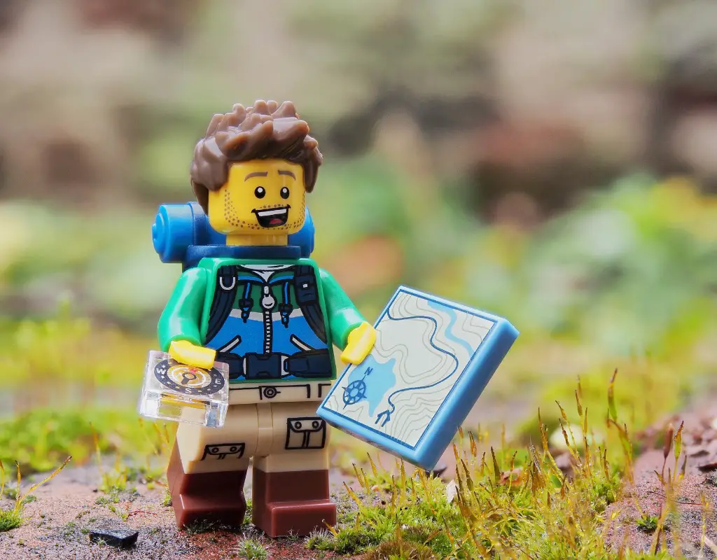 lego minifigure navigating with a map